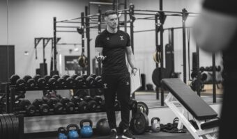 a-photo-of-a-sports-coach-in-a-gym-the-coach-is-st-YuQYKmxbT12AEpKfRbj_mg-kF6H8IZTQHKCnnFnXzwW3g